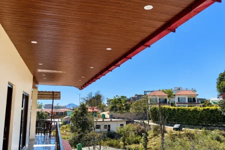 Sunlit Balcony Overlooking Hillside Homes
